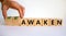 Reawaken symbol. Businessman turns cubes and changes the word \'awaken\' to \'reawaken\'.