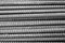 Rebar - black and white - closeup of horizontally stacked steel division reinforcement bars