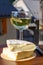 Reblochon French cheese made in Haute-Savoie, white Roussette de Savoie or Vin de Savoie wine with view on old alripne village and