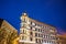 A rebuilt historic, Art Nouveau tenement house at night