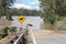 Receding Flood with Flood Debris on road on Brisbane River near Colleges Crossing 1st March 2022