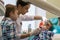 Reception at the dentistry. Two boys in the cabinet. The dentist examines the oral cavity.