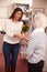 Receptionist Greeting Female Patient At Hearing Clinic