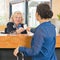 Receptionist helping a newly arriving hotel guest