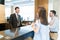 Receptionist Making Arrangement For Couple At Hotel