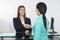 Receptionist Shaking Hand With Patient In Hospital