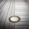Recessed floor lamp on old wooden floor - image with copy space