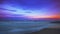 Recessing tide and moonrise over sandy ocean beach