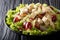 Recipe for delicious Sonoma salad with chicken breast, celery, pecans and grapes covered with sauce close-up. horizontal