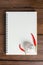 Recipe notebook, garlic, Red chilli on wooden background