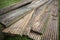 Reclaimed wooden decking planks on grass
