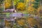 Reconstructed ancient huts at a lake in autumn