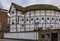 Reconstructed Shakespeare\'s Globe Theatre with thatched roof and old style timber-framed exterior in London, England