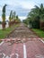 Reconstruction of the bike path. Replacing tiles on a bike path among palm trees
