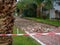 Reconstruction of the bike path. Replacing tiles on a bike path among palm trees. Infrastructure of the resort town. Repair