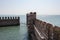 Reconstruction of Scaliger Castle fortification walls with horizon line on background, Sirmione, Lombardy, Italy