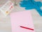 Record diagnosis,  medical report: the pink sheet of blank paper and red pen on it, around in selective focus, test tube, flask,