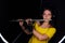 Record wind musical instruments with a professional microphone, black background. Woman flutist playing the metal flute. Female