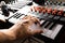 Recording studio. Professional studio equipment. Musician`s hand on midi keyboard. Close-up. Work with sound, podcast, recording