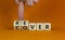 Recover symbol. Concept word `recover` on wooden cubes on a beautiful orange table. Businessman hand. Orange background. Busines