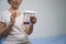 Recovering woman holds a postoperative lung simulator in her hands