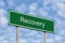 Recovery Concept, Green Signpost Road Sign, White Text, Grey Pole Posts, Blue Sky, Bright Cloudscape Clouds, Large Detailed