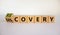 Recovery or discovery symbol. Turned a wooden cube, changed a word `discovery` to `recovery`. Beautiful white background. Busi