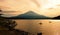 Recreational anglers silhouette fishing in front of Mount Fuji at dusk