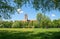 Recreational area Isar river munich, green meadow, view through willow branches to church St. Maximilian