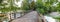 Recreational area at munich, bridge over isar river with green branches