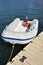 Recreational inflatable white rubber raft with outboard motor