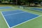 Recreational sport of pickleball court in Michigan, USA looking at an empty blue and green new court at a outdoor park