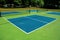 Recreational sport of pickleball court in Michigan, USA looking at an empty blue and green new court at a outdoor park