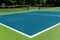 Recreational sport of pickleball court in Michigan, USA looking at an empty blue and green new court at a outdoor park. Ground