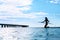 Recreational Water Sports. Woman Silhouette On Surfboard In Ocean. Wellness