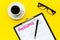 Recruitment. Select employees. Resume near coffee, glasses on yellow background top view