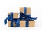 Rectangle box wrapped in brown kraft paper and tied with a silk blue ribbon