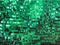 Rectangular green sequined fabric texture - shiny green sparkling sequins background. Festive, carnival or fashion background