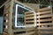 Rectangular illuminated mirror hanging on pallets