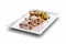 Rectangular plate with veal with tuna sauce chives caper flowers and grilled vegetables