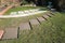 Rectangular sections cut into a lawn with concrete bases prepared for stepping stones.