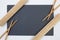 Rectangular slate plate with chopsticks, bamboo mat  for sushi on the white table