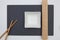 Rectangular slate plate with chopsticks, bamboo mat  for sushi on the white table