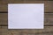 Rectangular white paper at weathered wood textured background with copy space for your message. A wish list.