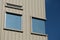 Rectangular windows on corrugated building facade
