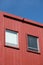 Rectangular windows on red building facade