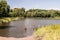 Recultivated landscape with lake, forest and blue sky with clouds near Orlova city