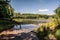 Recultivated landscape with lake, forest and blue sky with clouds near Orlova city