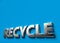 Recycle 3D sign or logo concept placed on blue surface with copy space above it. New recyclable and ecological technologies