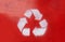 Recycle sign on red background and three white arrows. Eco way to protect the planet